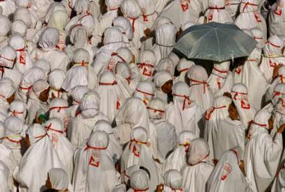 Women pilgrims from eastern Asia walk to perform the Jamarat
