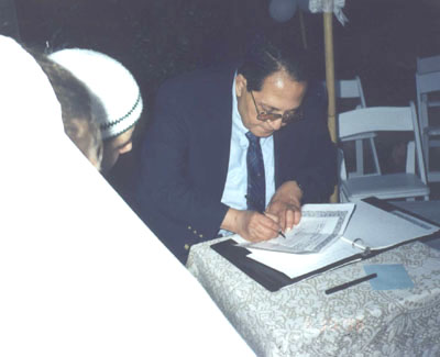 The signing of the contract by the groom's father
