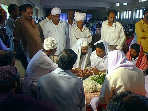 A Muslim wedding in Kerala state India The father of the bride performing