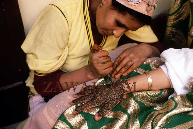 Applying henna to a bride's hand