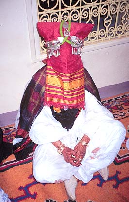 Bride with henna hands and hat