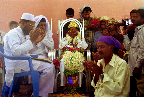 Men and the groom pray in a colorful muslim wedding in south Karnataka 