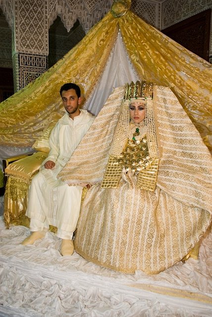 a traditional wedding dress with gold jewelry