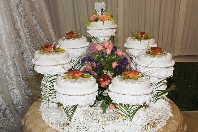 The wedding cake is actually seven cakes around a centerpiece