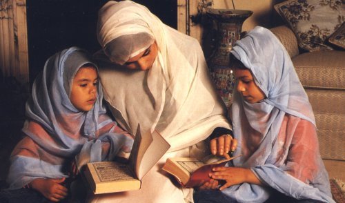 Muslim mother reads Quran with her daughters