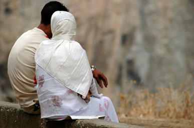 Muslim couple sitting close together