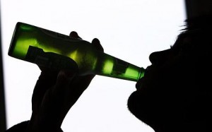 Man drinking alcohol from a bottle