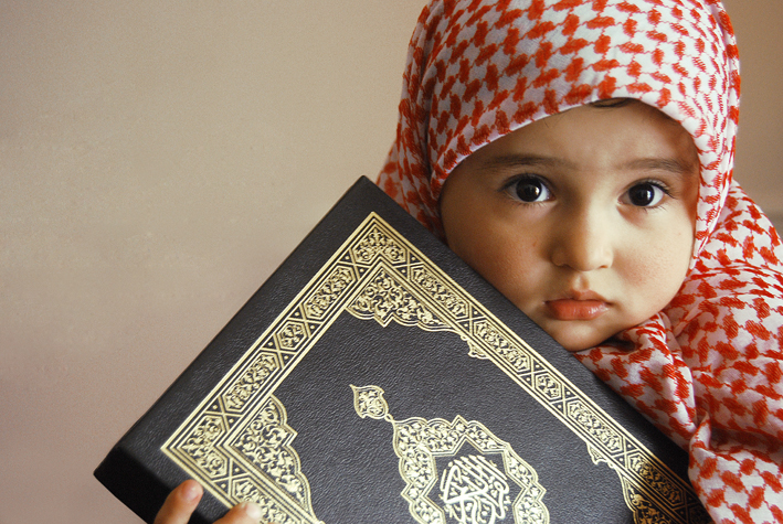Cute-little-muslim-baby-holing-Holy-Quran