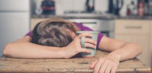 Tired woman with coffee mug