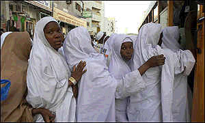 Pilgrims line up to board a bus