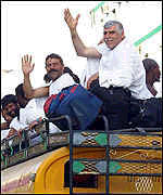 Pilgrims sit on roofs on buses