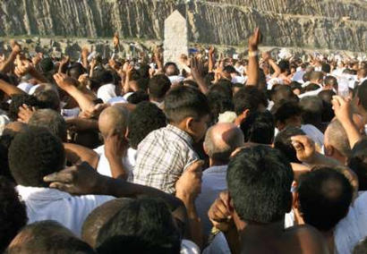 Hajj pilgrims at Mina perform the Jamarat.