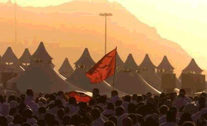 Hajj pilgrims walk in a tent camp