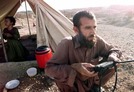Afghan refugee listens for news
