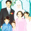 The couple with the bride's younger sisters and brother
