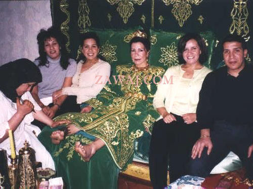 Fatiha has henna applied to her feet.