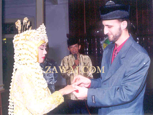 Placing the ring on the bride's finger.