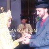 Placing the ring on the bride's finger.