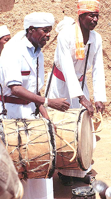 Men play barrel drums at the wedding festival