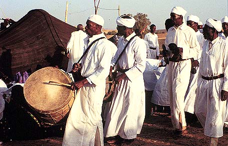 Men play drums at the wedding festival