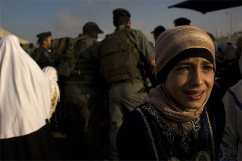 Palestinian girl cries at a checkpoint